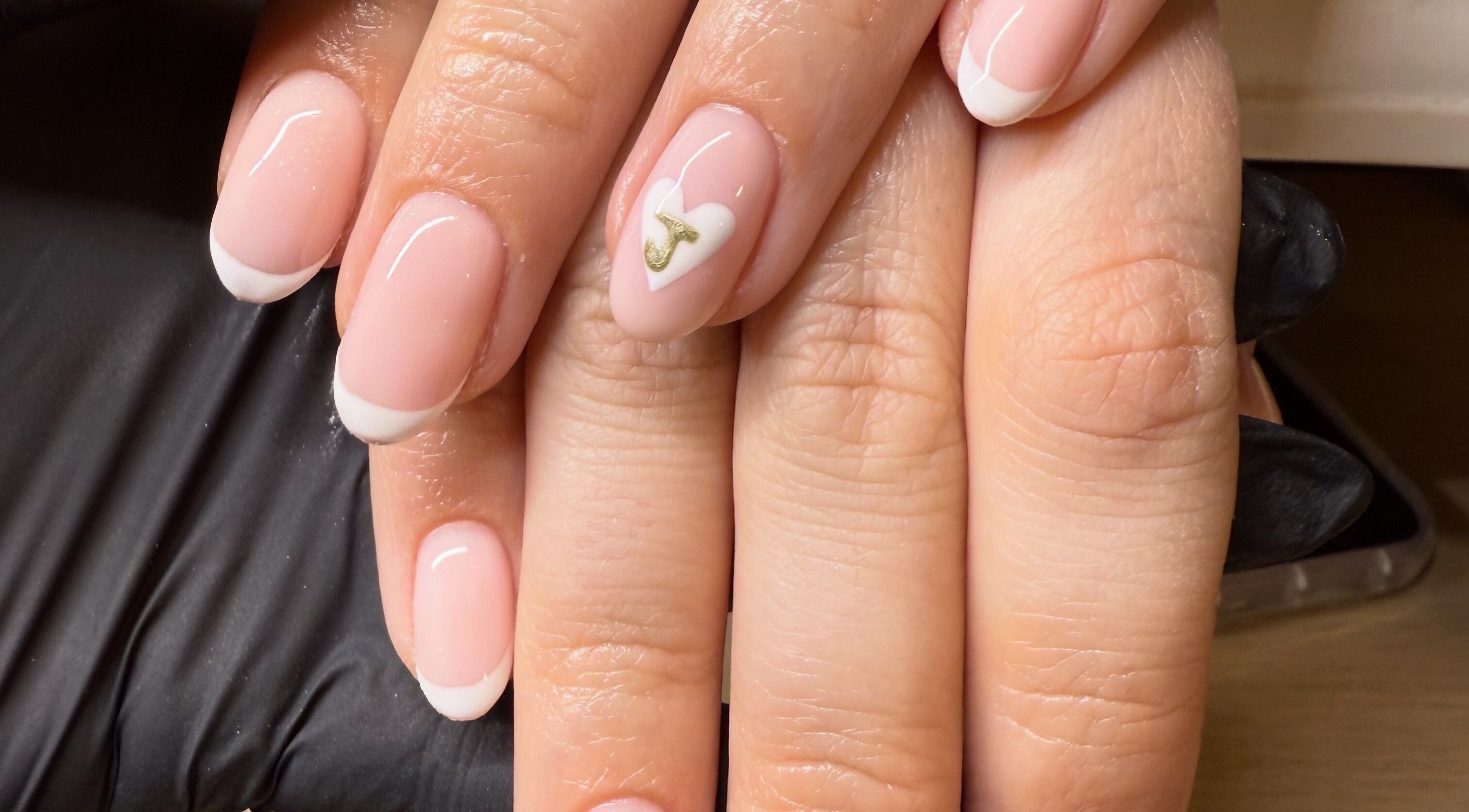 Elegant French manicure with heart detail at Bonnie Beauty, Betley, England, GB.