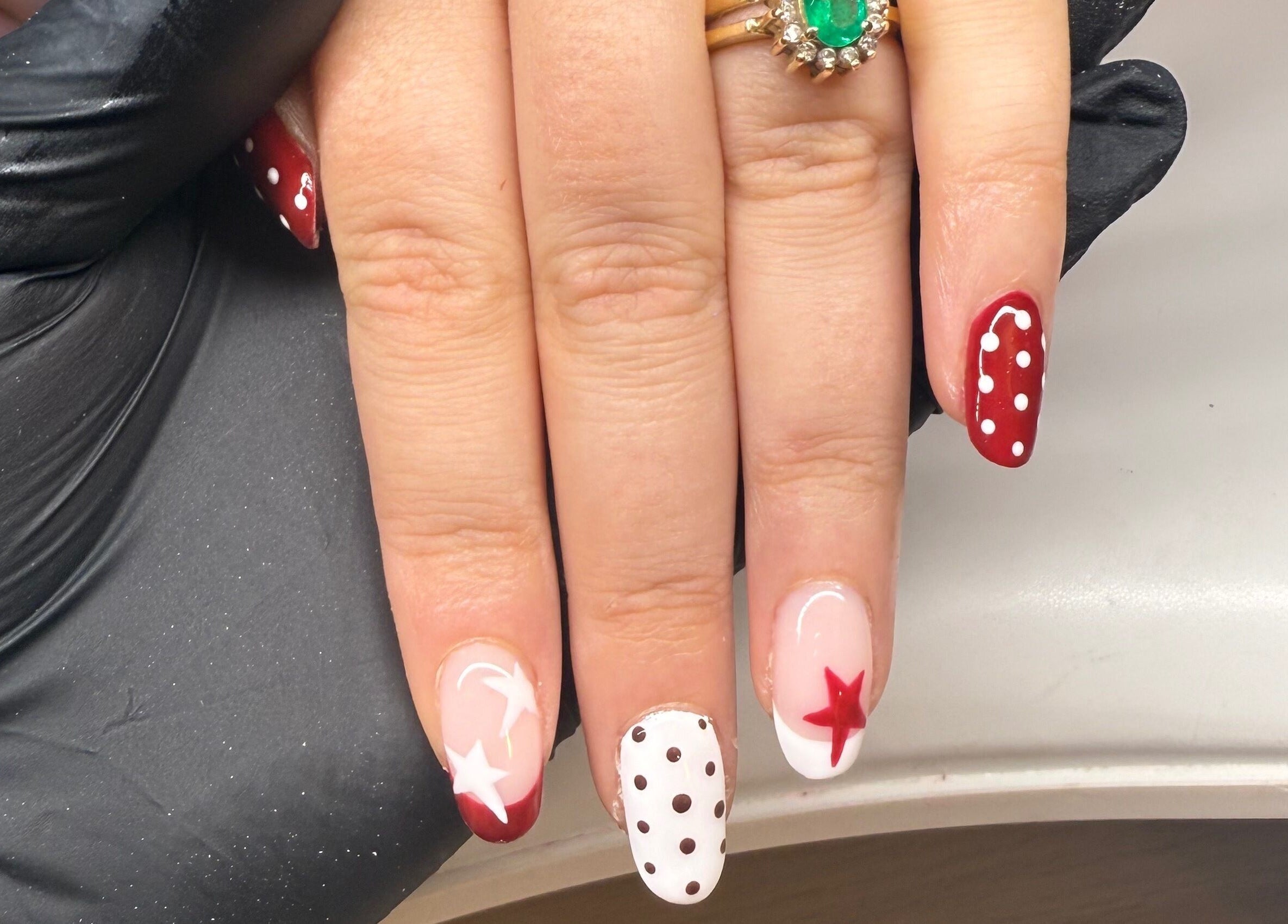 Red and white star polka dot nails design at Bonnie Beauty in Betley, England, GB.