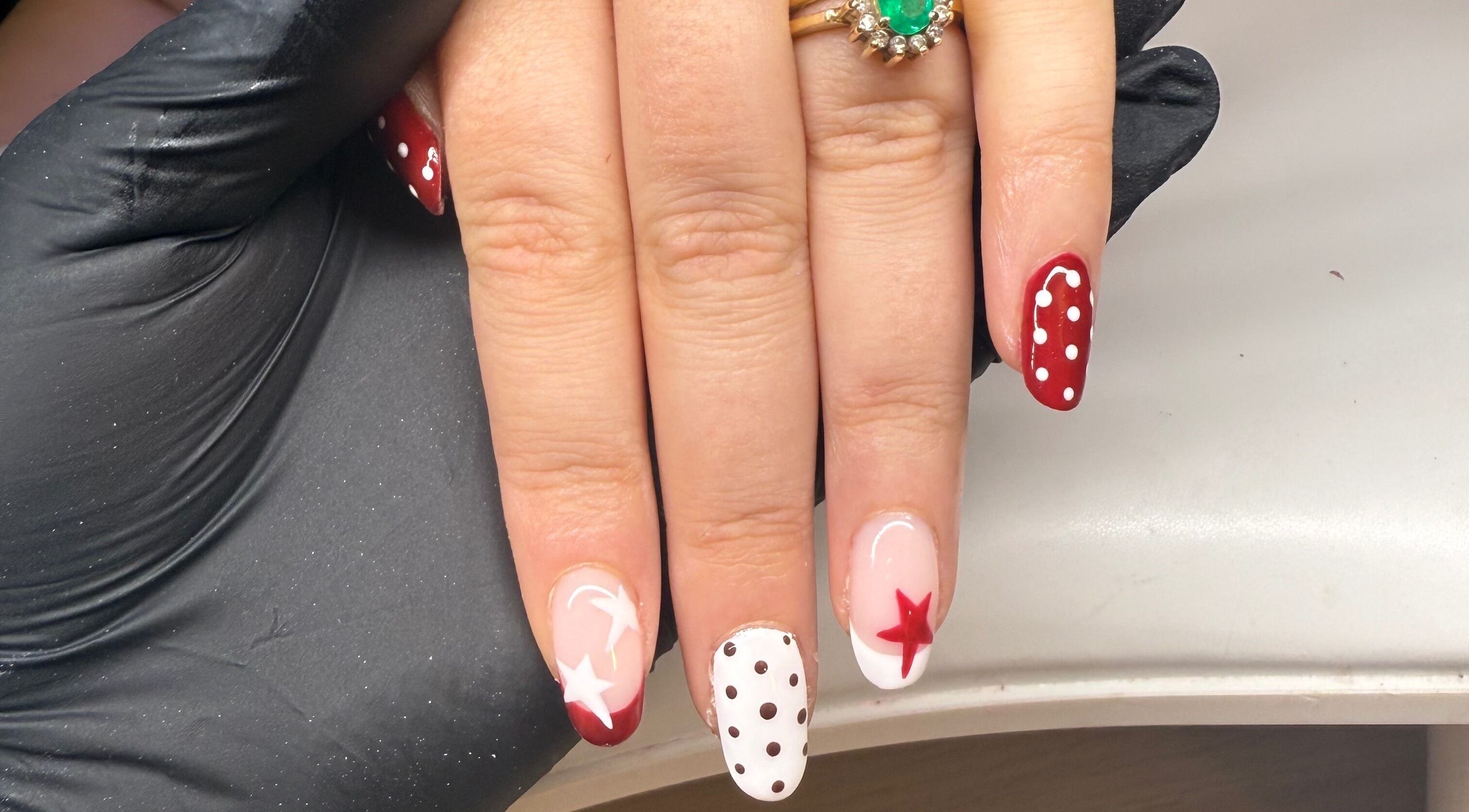 Red and white star polka dot nails design at Bonnie Beauty in Betley, England, GB.