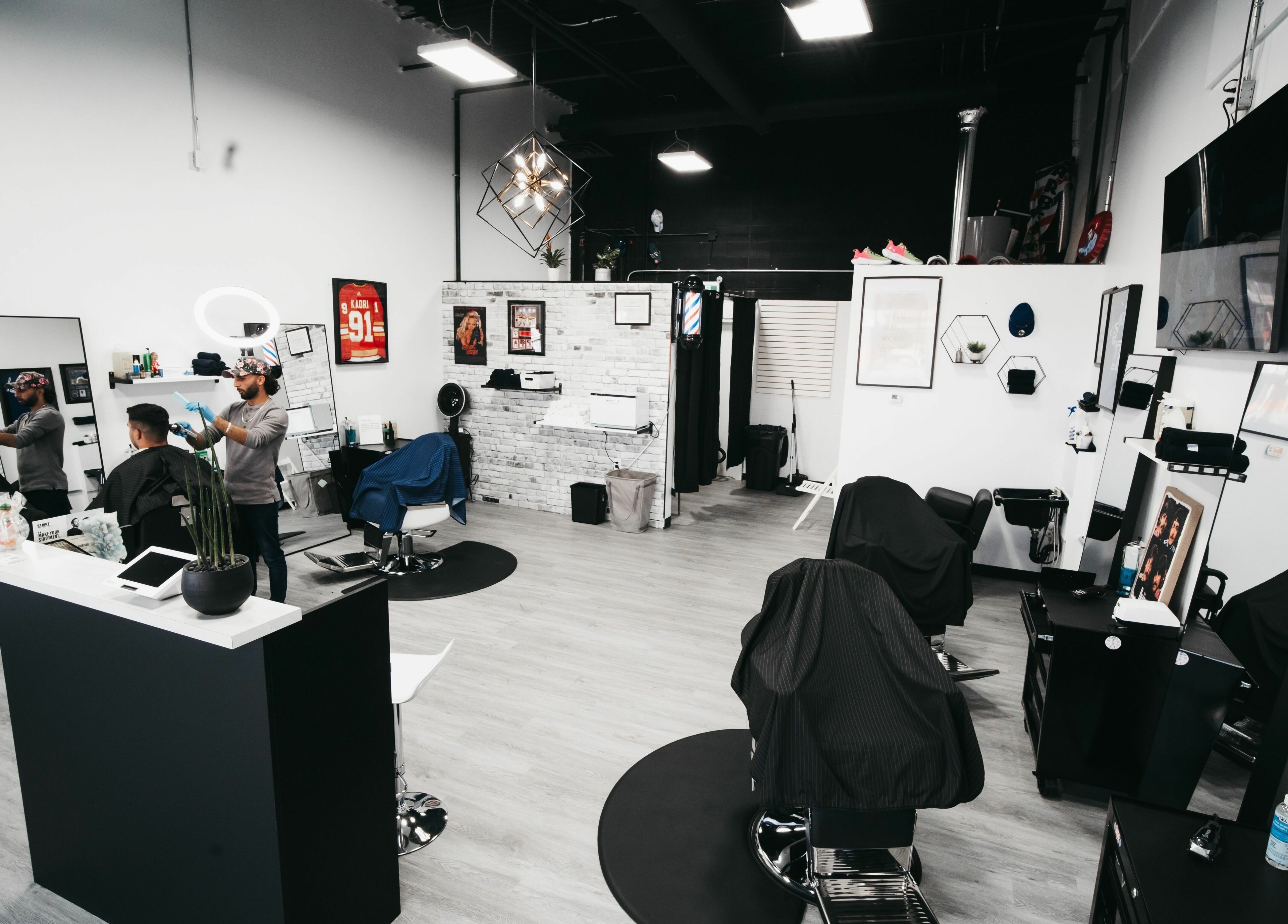 Spacious interior of Macleod Trail Barbers, Calgary, Alberta, CA, featuring sleek decor and professional barber chairs.