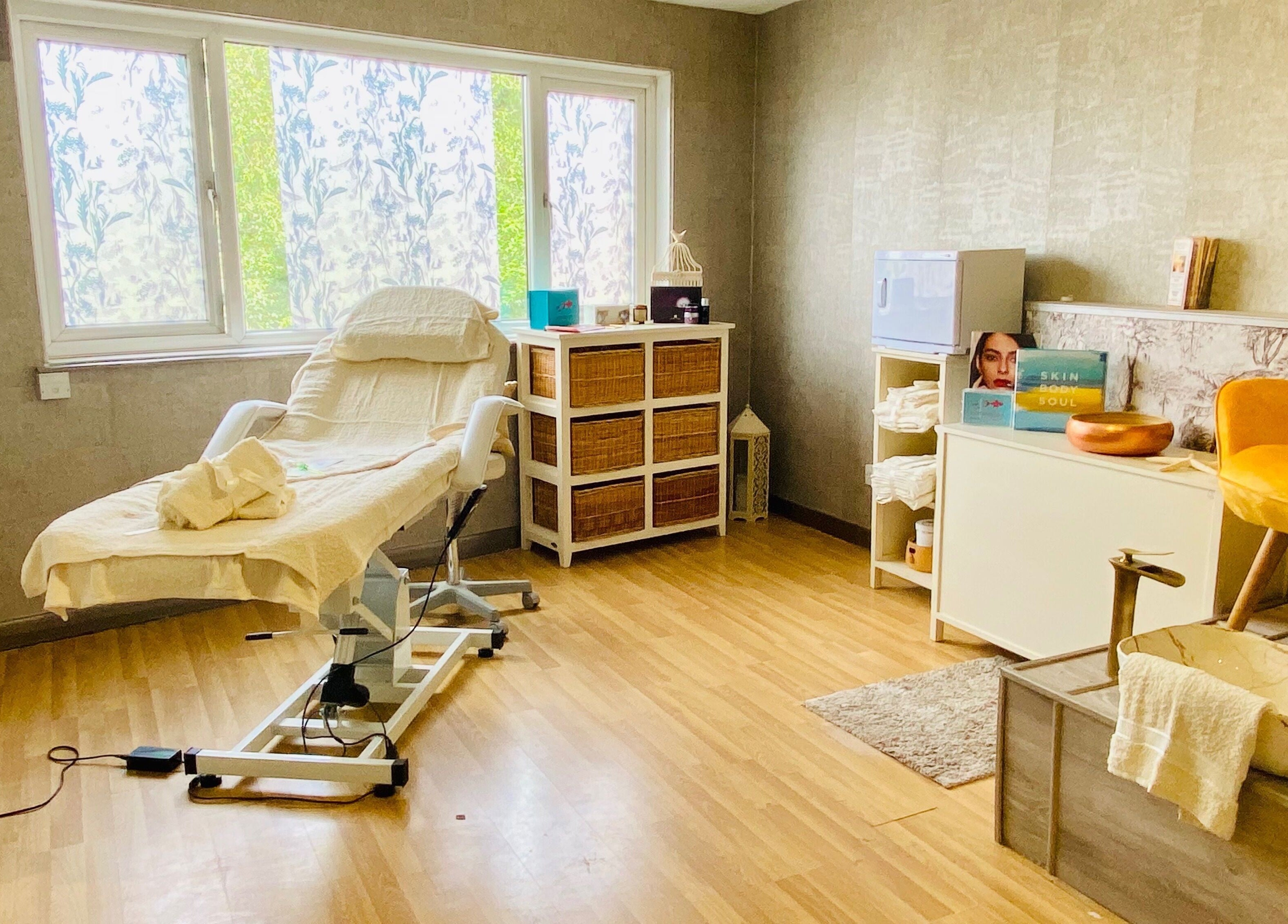 Cozy treatment room at Celestial Glow, Brockenhurst, England, GB offering a serene wellness experience.