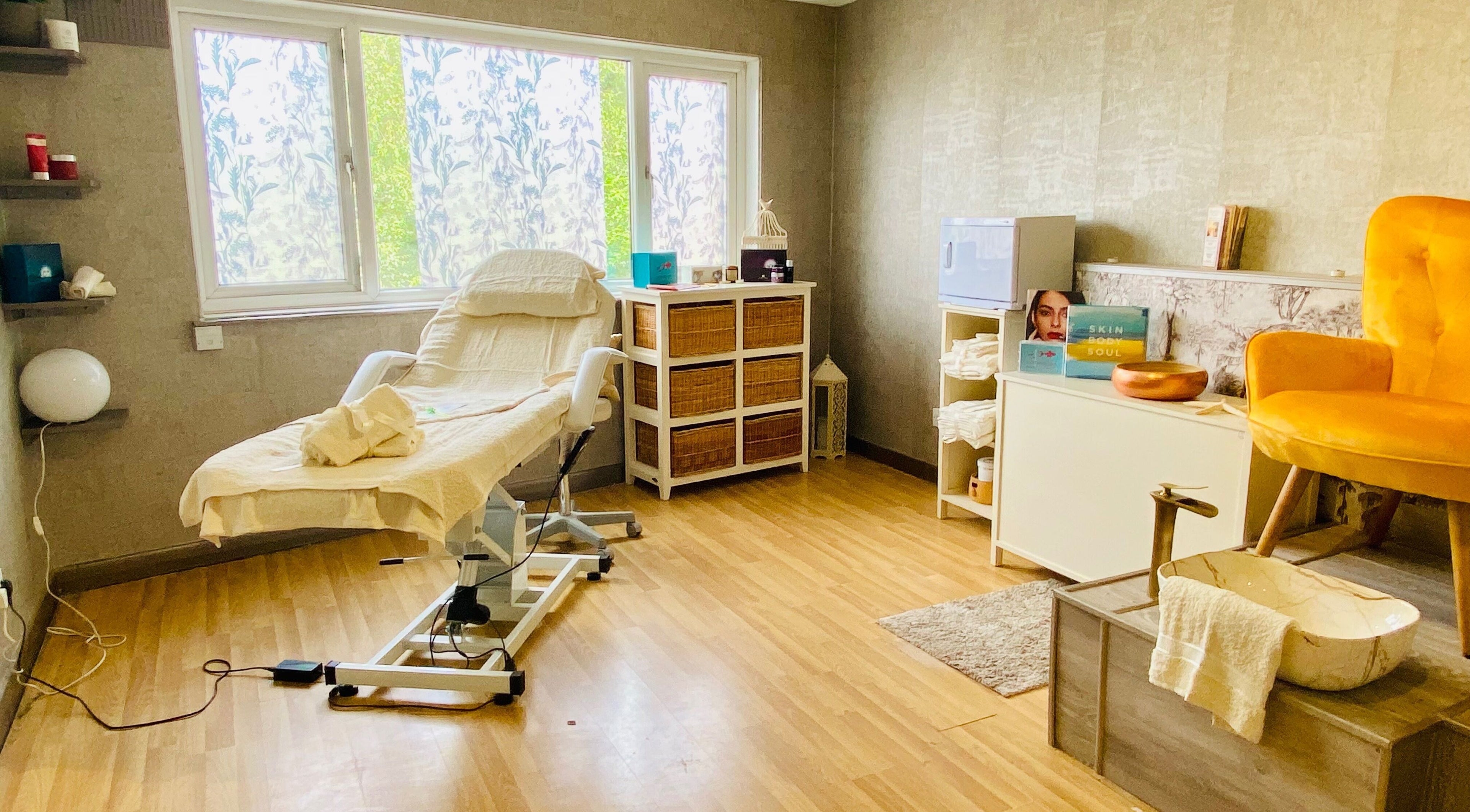 Cozy treatment room at Celestial Glow, Brockenhurst, England, GB offering a serene wellness experience.