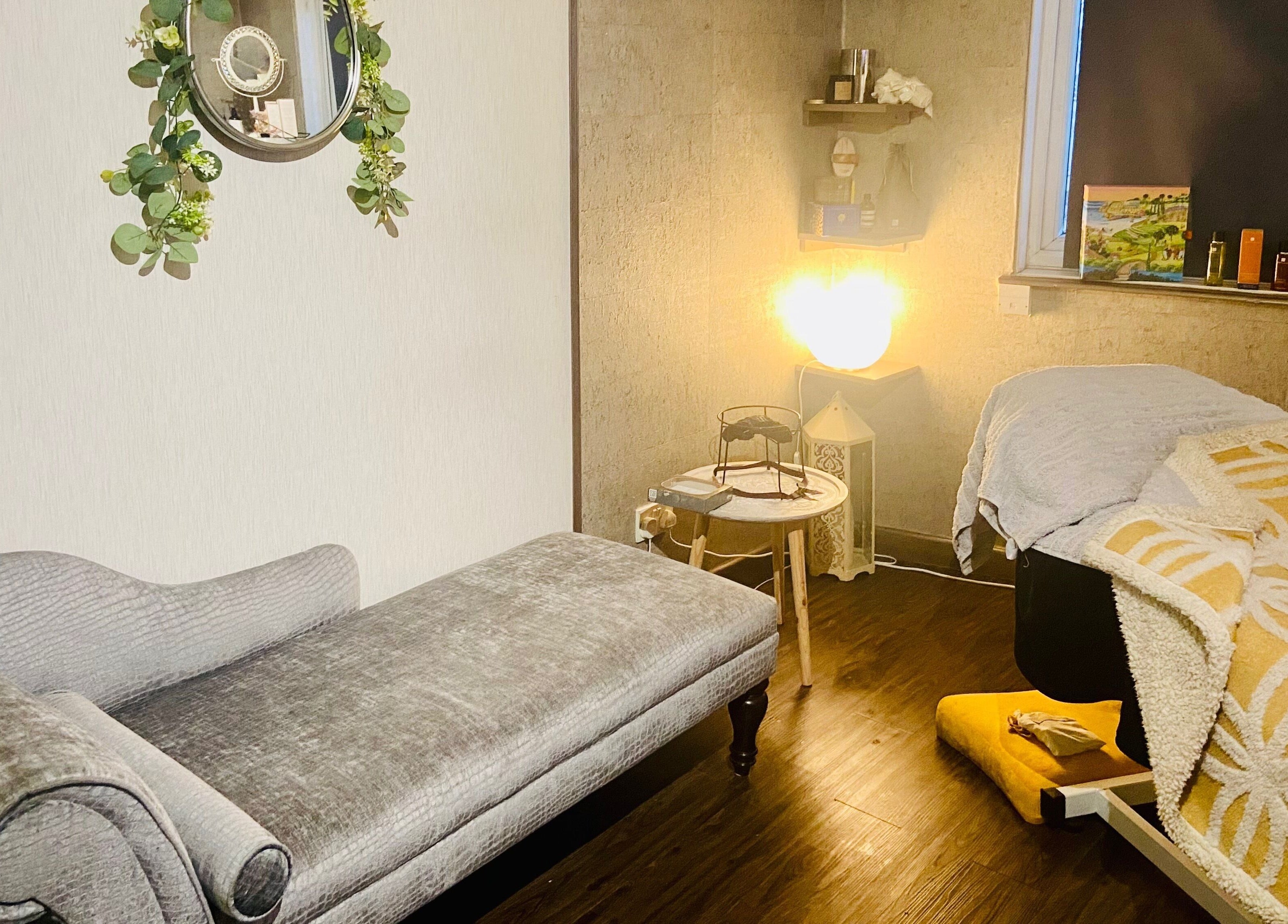 Cozy therapy room at Celestial Glow, Brockenhurst, England, GB, with plush seating and ambient lighting.