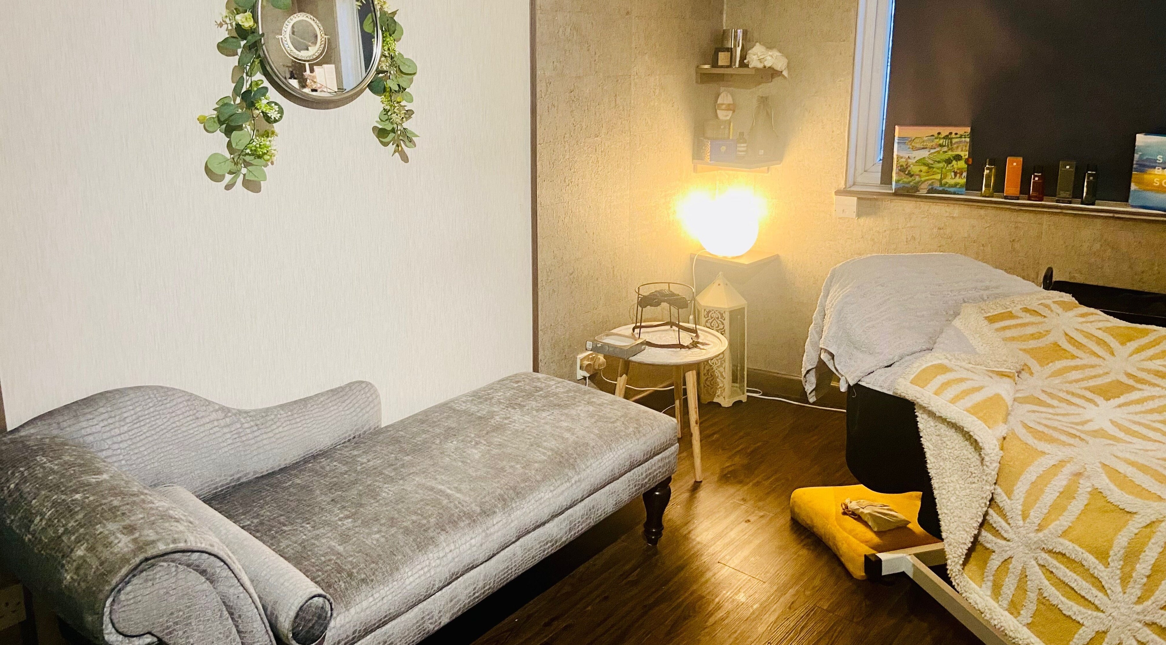 Cozy therapy room at Celestial Glow, Brockenhurst, England, GB, with plush seating and ambient lighting.