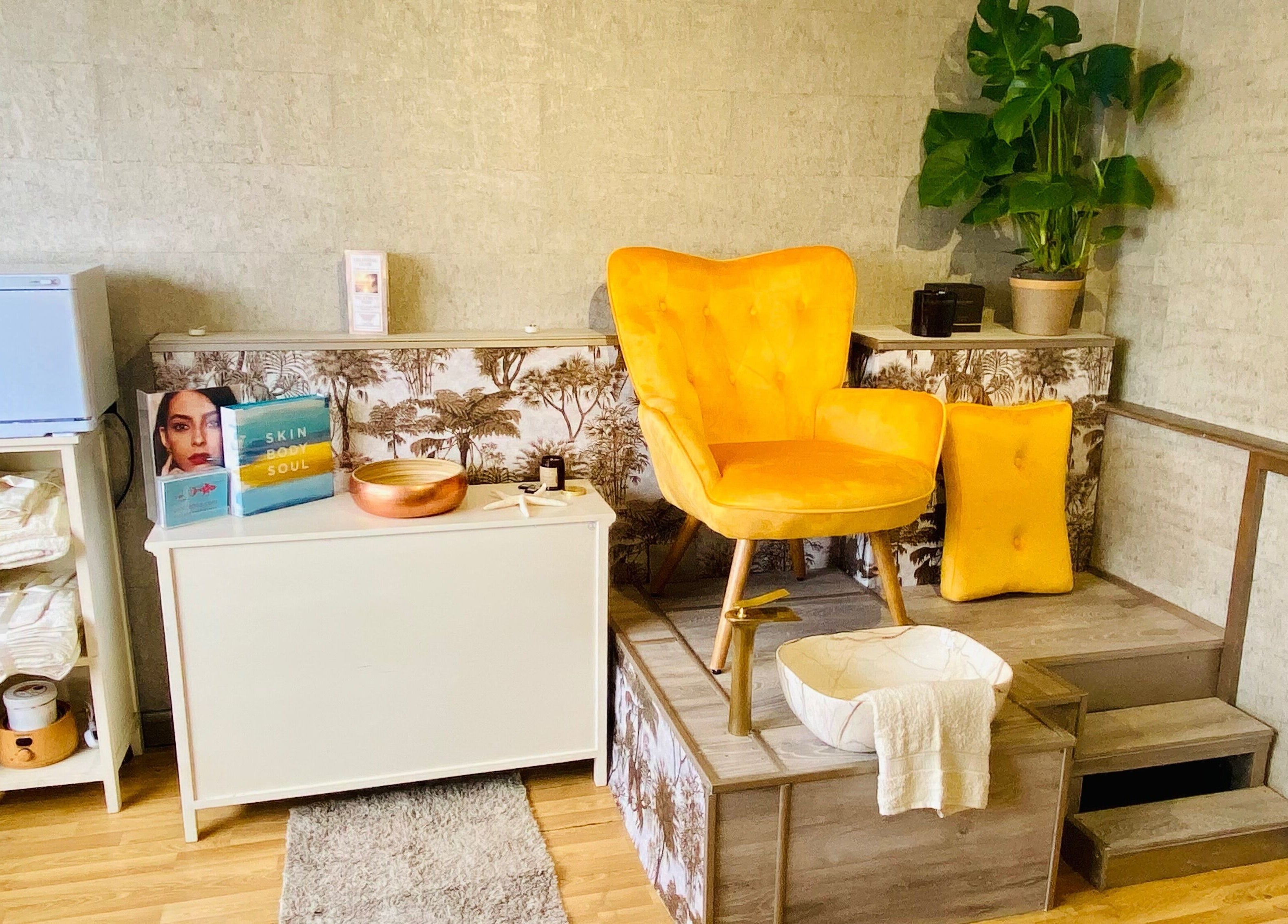 Relaxing pedicure setup at Celestial Glow, Brockenhurst, England, GB with a vibrant yellow chair.