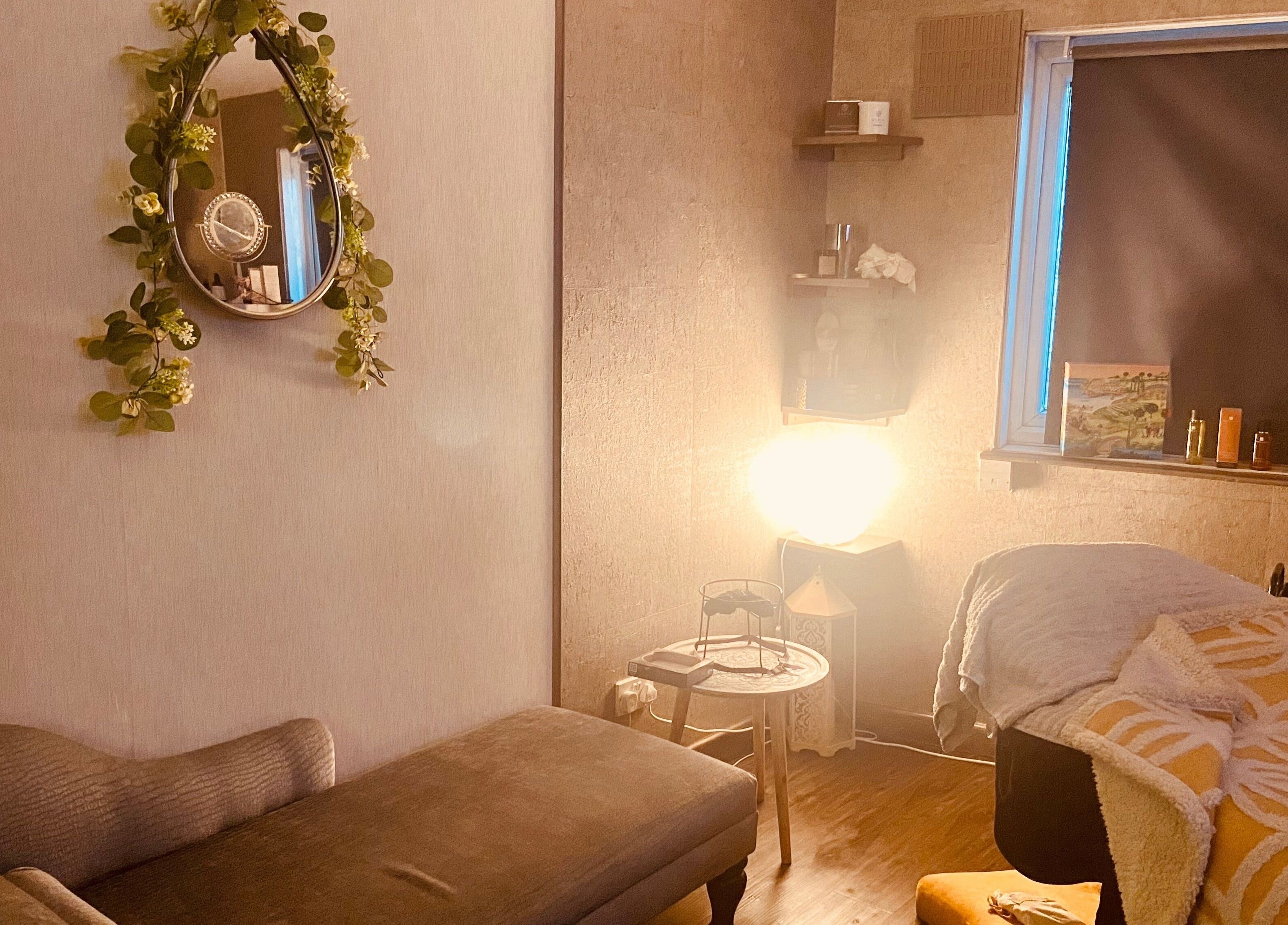 Cozy treatment room at Celestial Glow in Brockenhurst, England, GB with stylish decor and soft lighting.