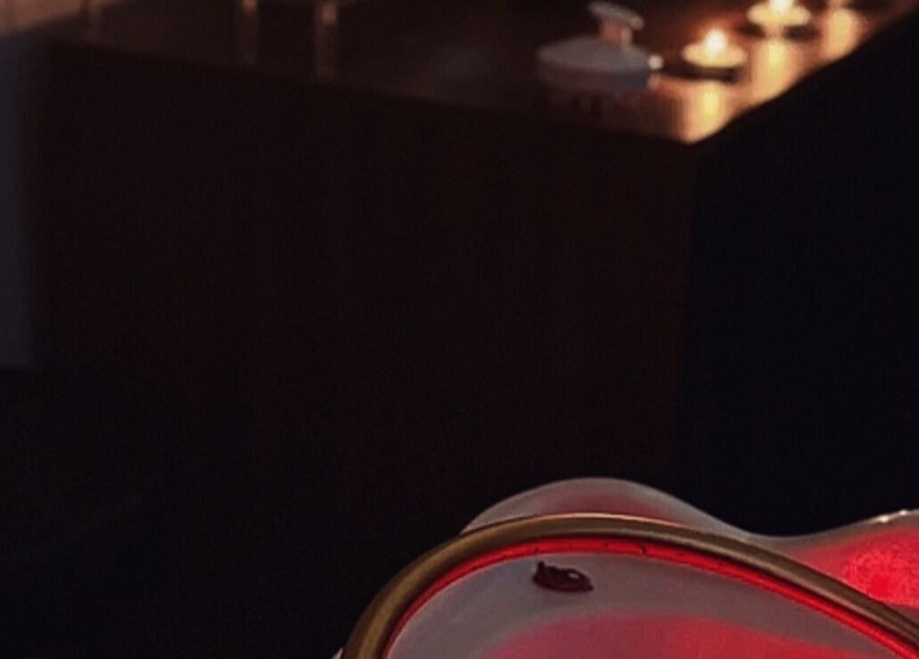 Ambient spa room at The Signature Edit - Bedew Skin in Corby, England, GB, illuminated by soft candlelight.