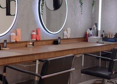 Modern styling stations at Danilo Possato Hair Studio, Dublin, County Dublin, IE, with sleek mirrors and chairs.