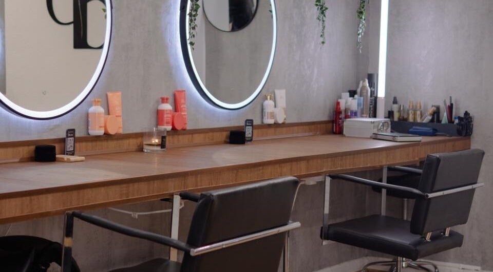 Modern styling stations at Danilo Possato Hair Studio, Dublin, County Dublin, IE, with sleek mirrors and chairs.
