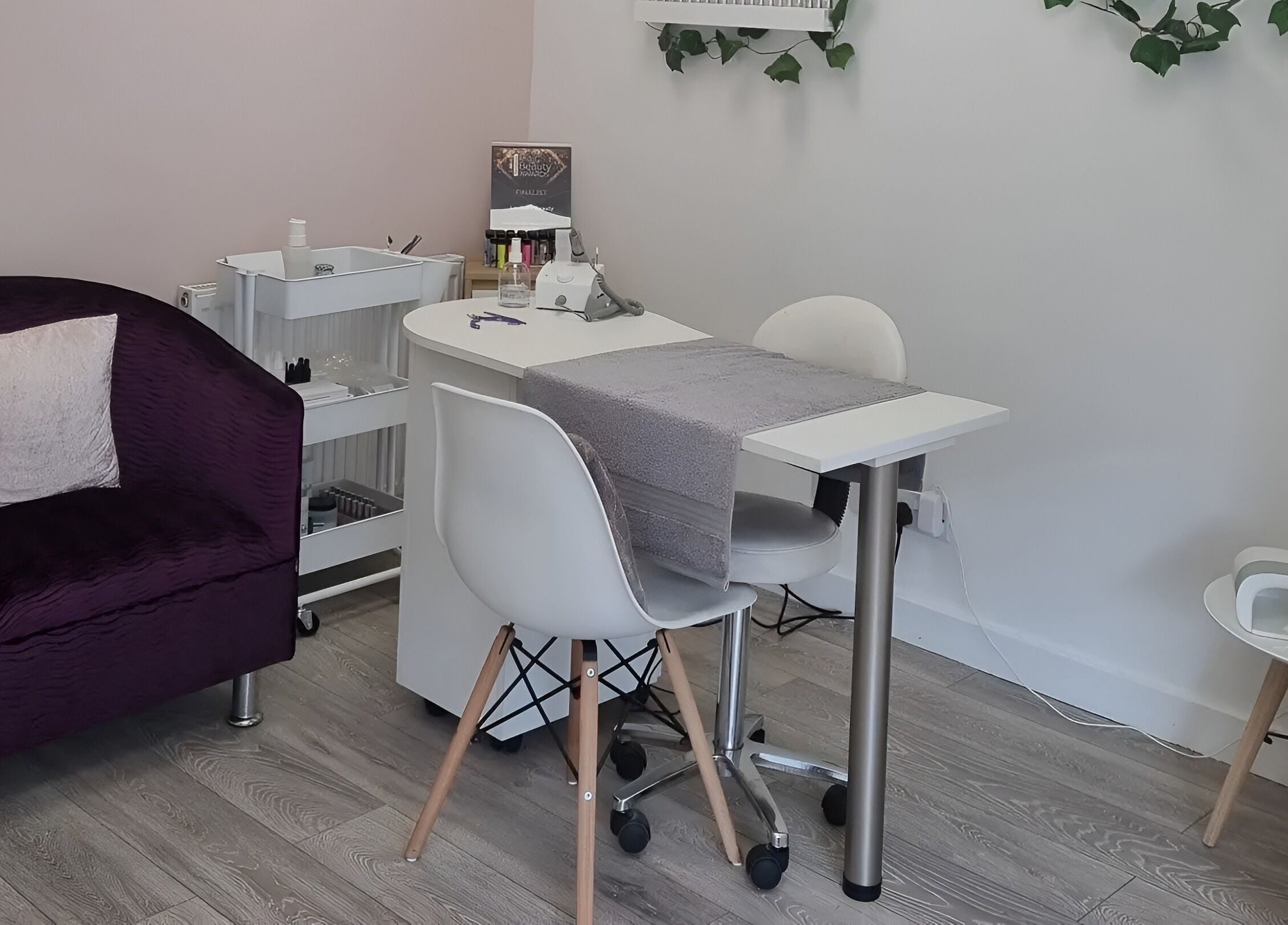 Cozy manicure area at Loubelle Beauty in Aberdeen, Scotland, GB, featuring elegant seating and decor.