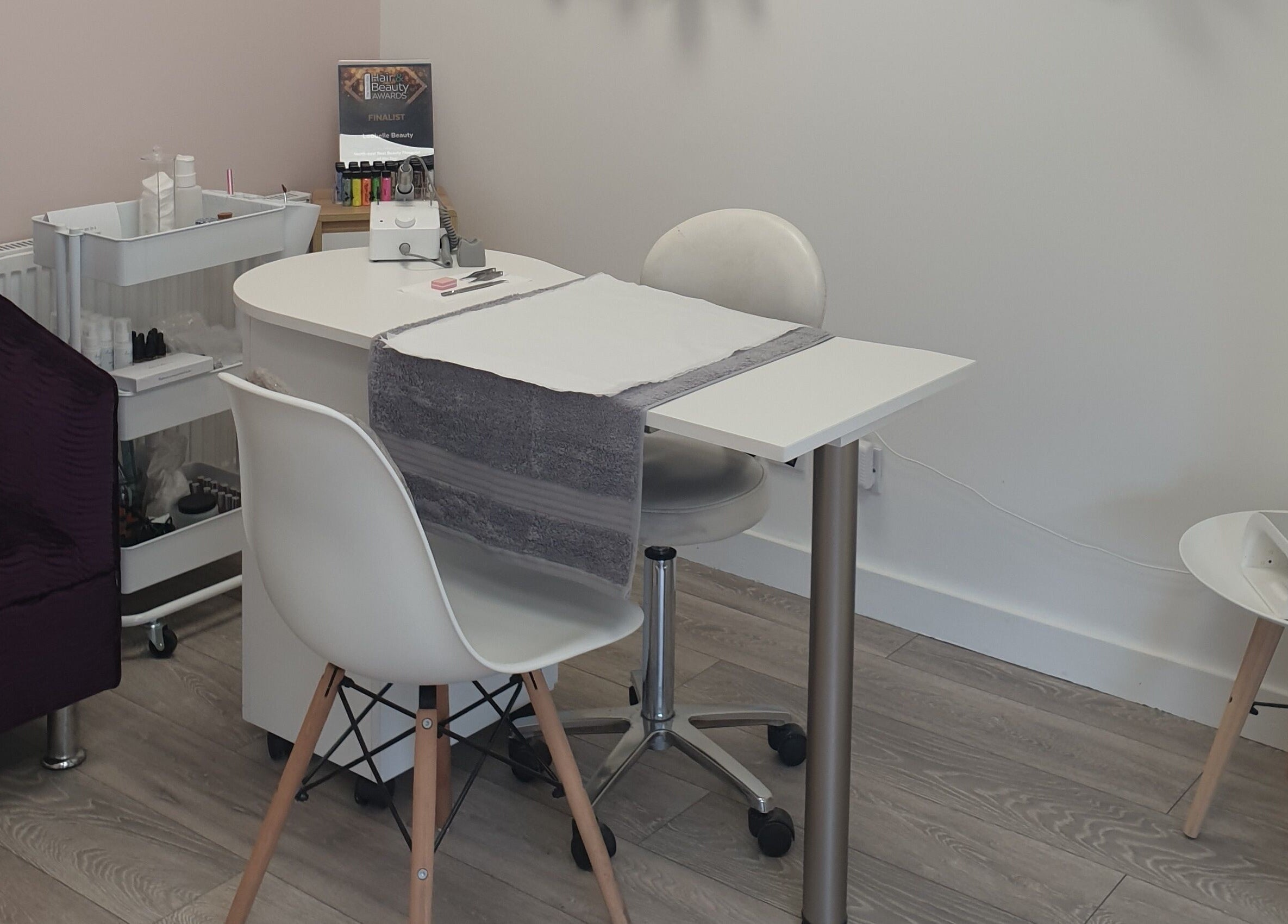 Modern nail care station at Loubelle Beauty, Aberdeen, Scotland, GB, featuring chic décor and organized workspace.
