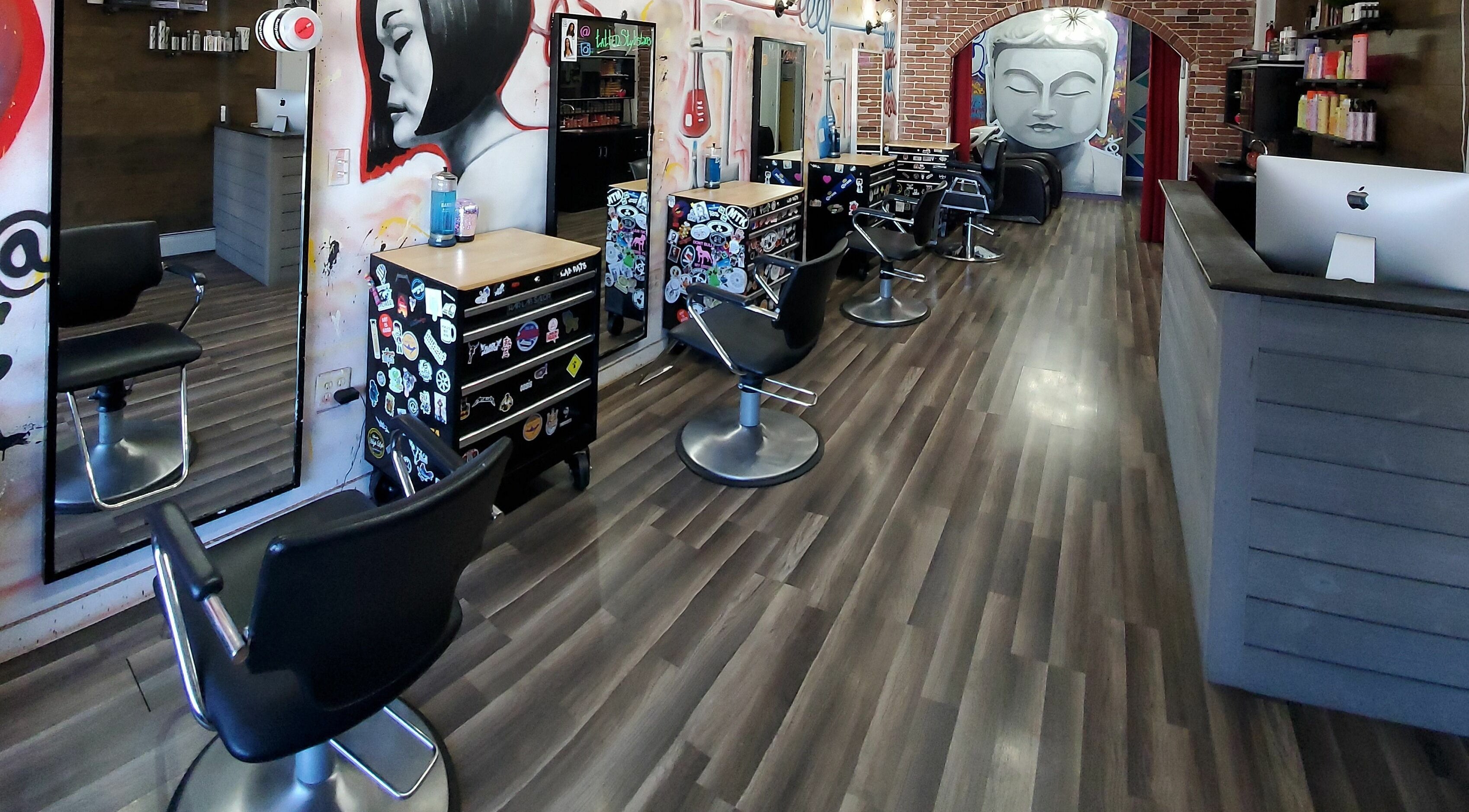 Interior of The Hair Lab Salon in Norwalk, Connecticut, US, featuring modern chairs and vibrant wall art.