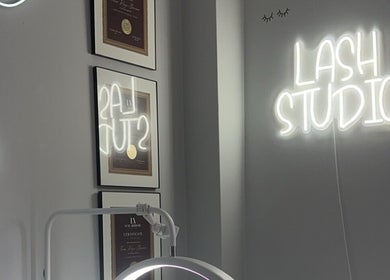 Lash Studio neon sign and certificates at Femme Theory, London, Ontario, CA highlighting beauty services.