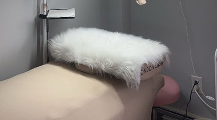 Relaxing beauty treatment bed at Femme Theory, London, Ontario, CA, adorned with a fluffy white cover.