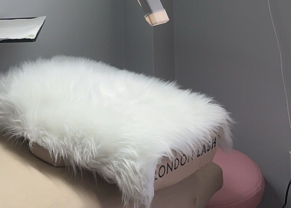 Cozy spa bed with fluffy fur overlay at Femme Theory in London, Ontario, CA.