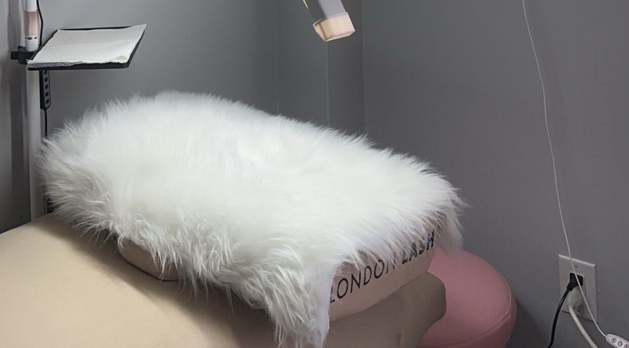 Cozy spa bed with fluffy fur overlay at Femme Theory in London, Ontario, CA.