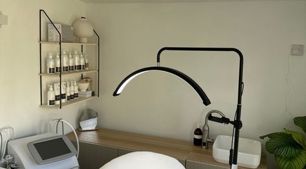 The Advanced Skin Cabin in Peterborough, England features a cozy treatment room with skincare products displayed elegantly.