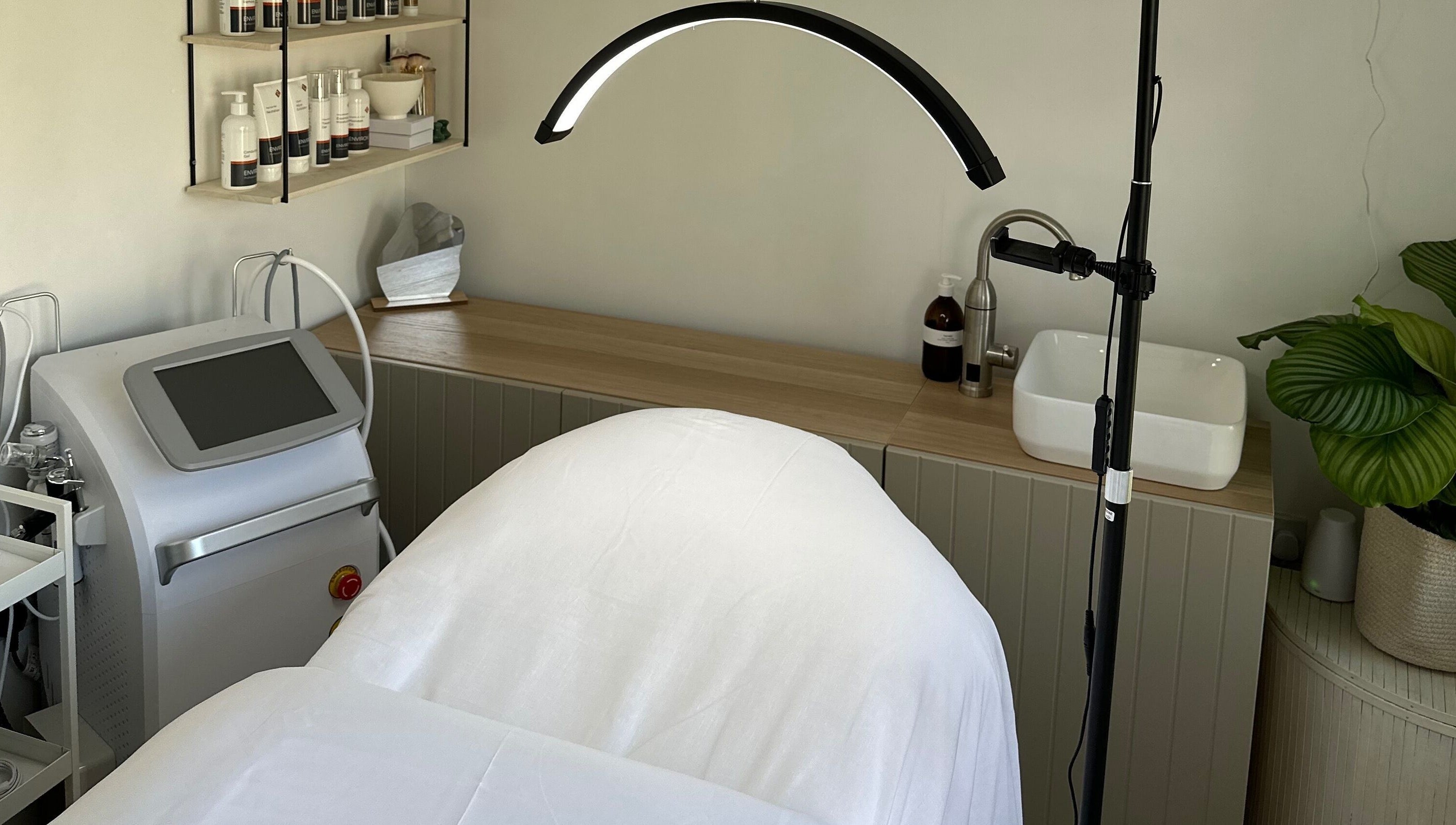 The Advanced Skin Cabin in Peterborough, England, GB. Display of a serene treatment space with skincare products.