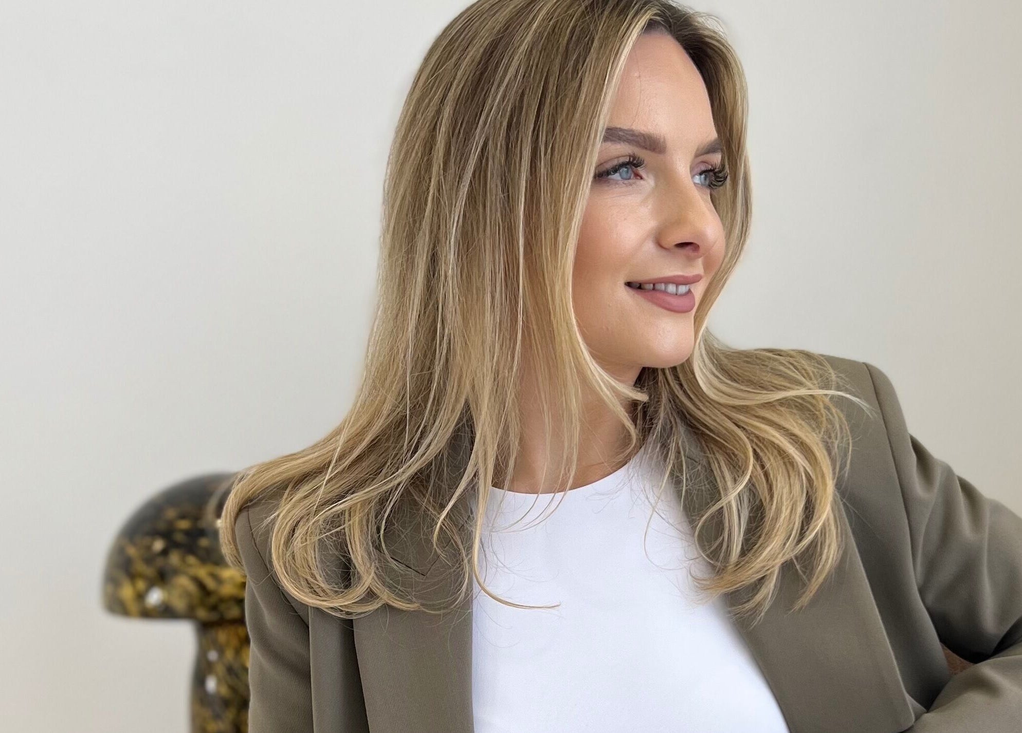 Elegant woman with blonde hair smiling at The Advanced Skin Cabin, Peterborough, England, GB.