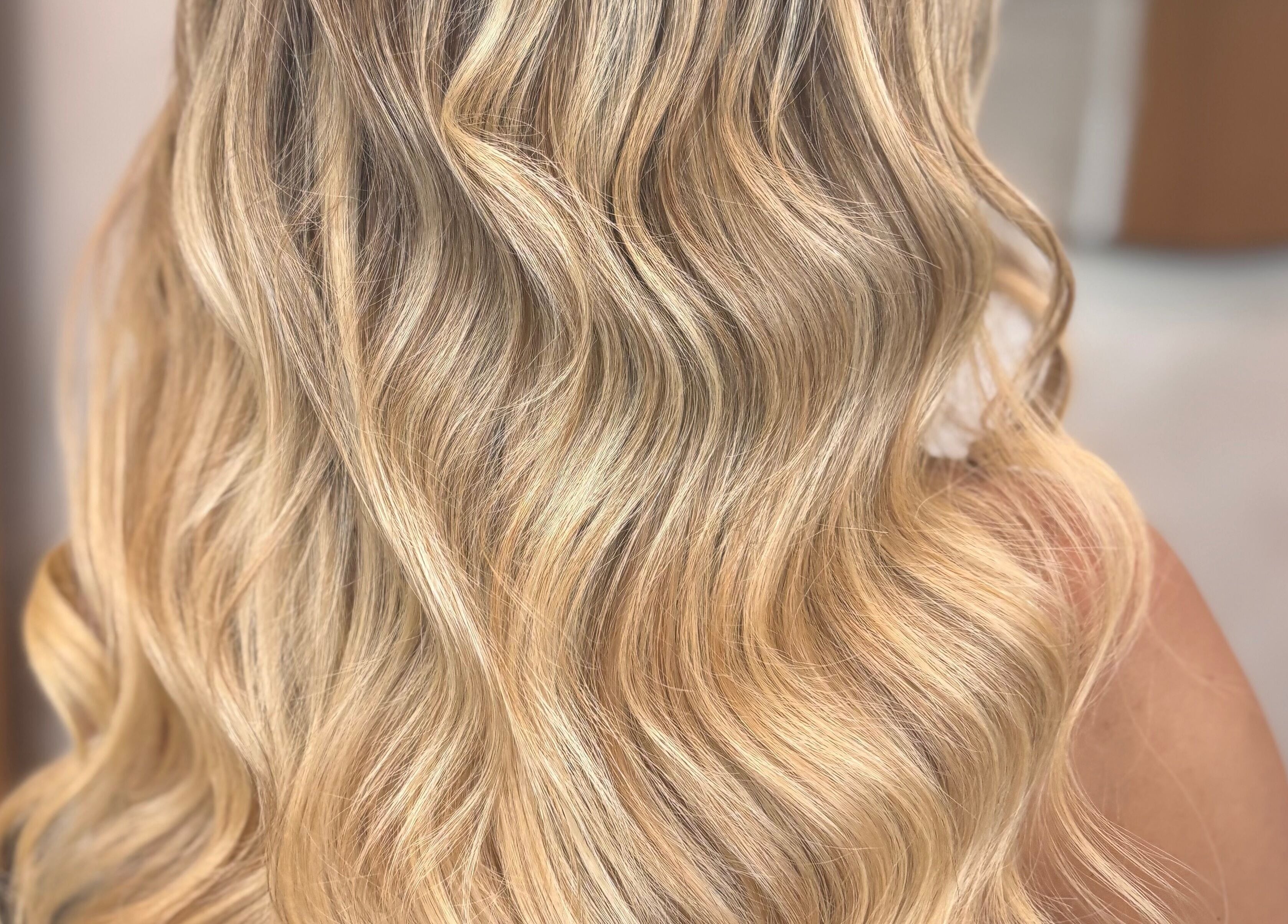 Elegant blonde waves styled by Signature Blonde in Leeds, England, GB, showcasing luxury hair treatments.