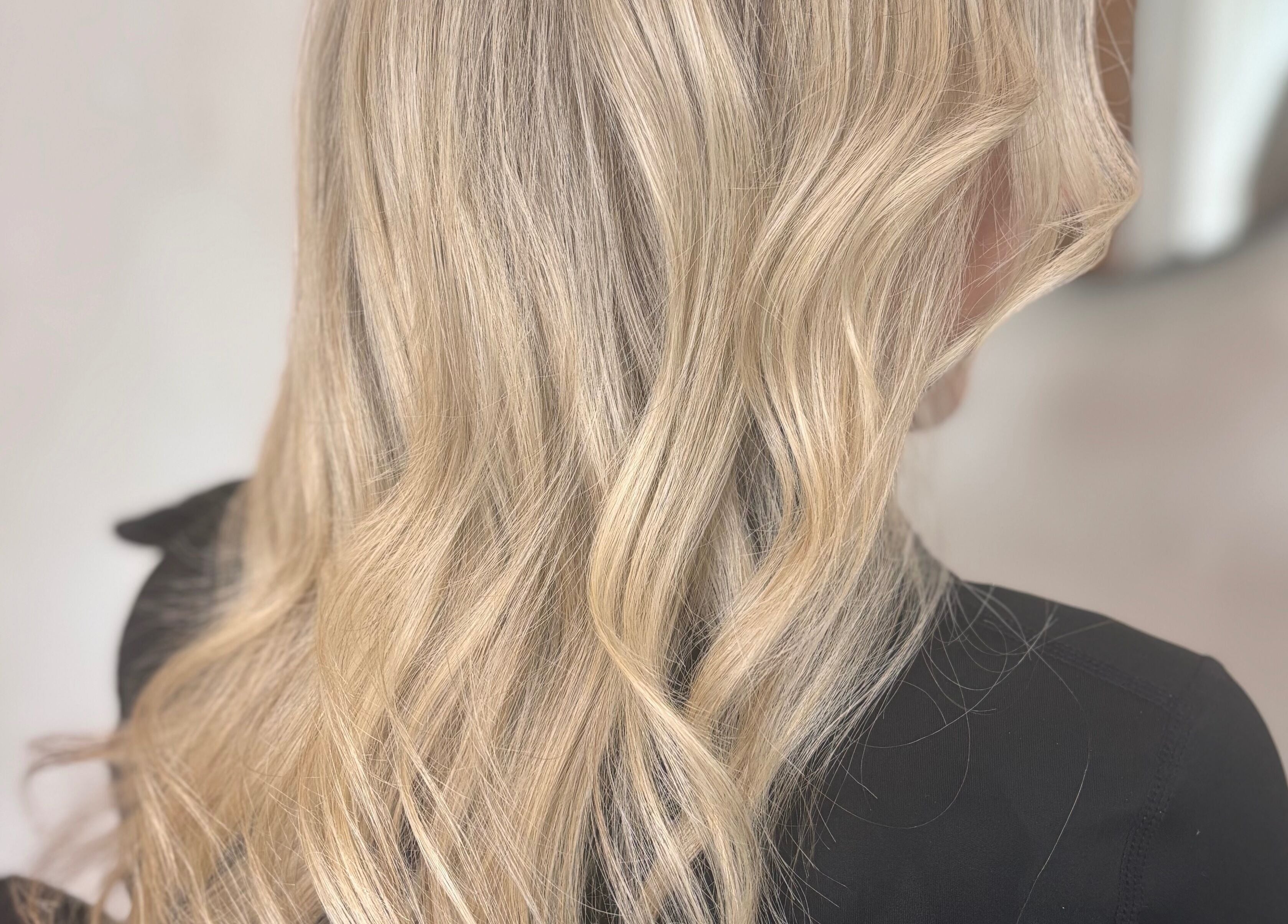 Blonde wavy hair styled at Signature Blonde, Leeds, England, GB. Perfect blend of elegance and style.