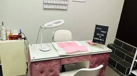 Nail station at Sempré Bella by Noushka, Johannesburg, Gauteng, ZA, with pink accents and modern decor.