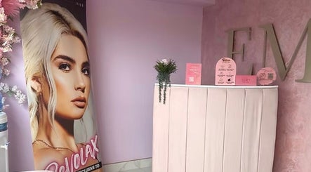 Stylish reception at Eme Beauty Studios in Dudley, England, GB with elegant decor and poster display.