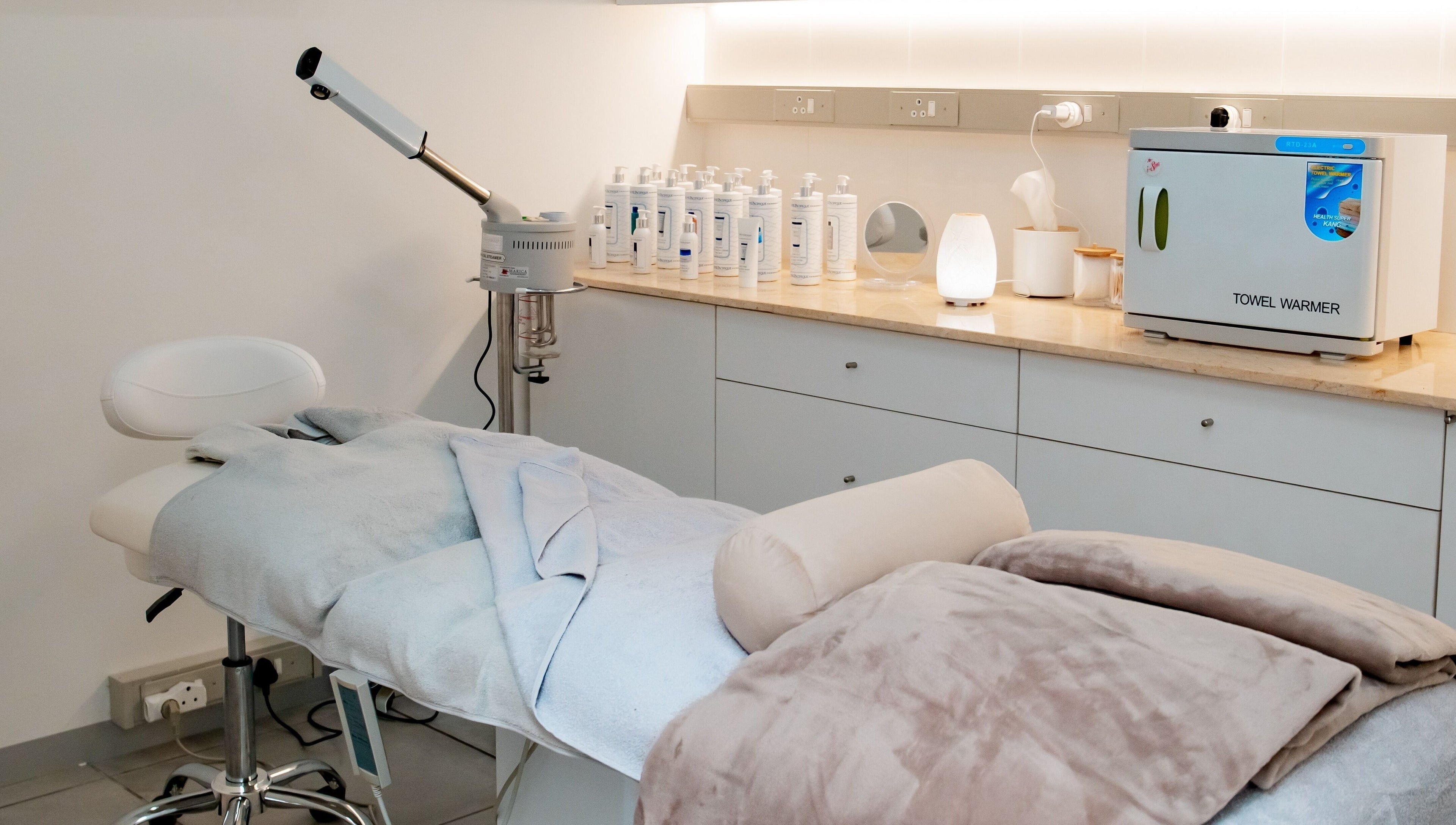 Serene treatment room at Anue Medical Spa, Gaborone City, BW featuring a comfy bed and skincare essentials.