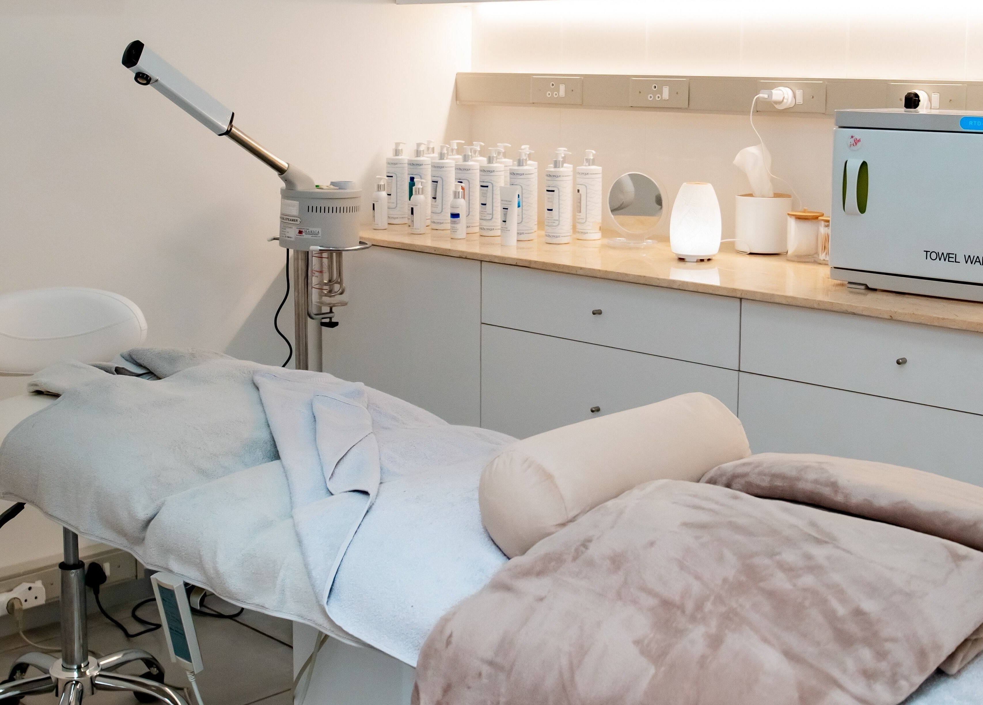 Serene treatment room at Anue Medical Spa, Gaborone City, BW featuring a comfy bed and skincare essentials.