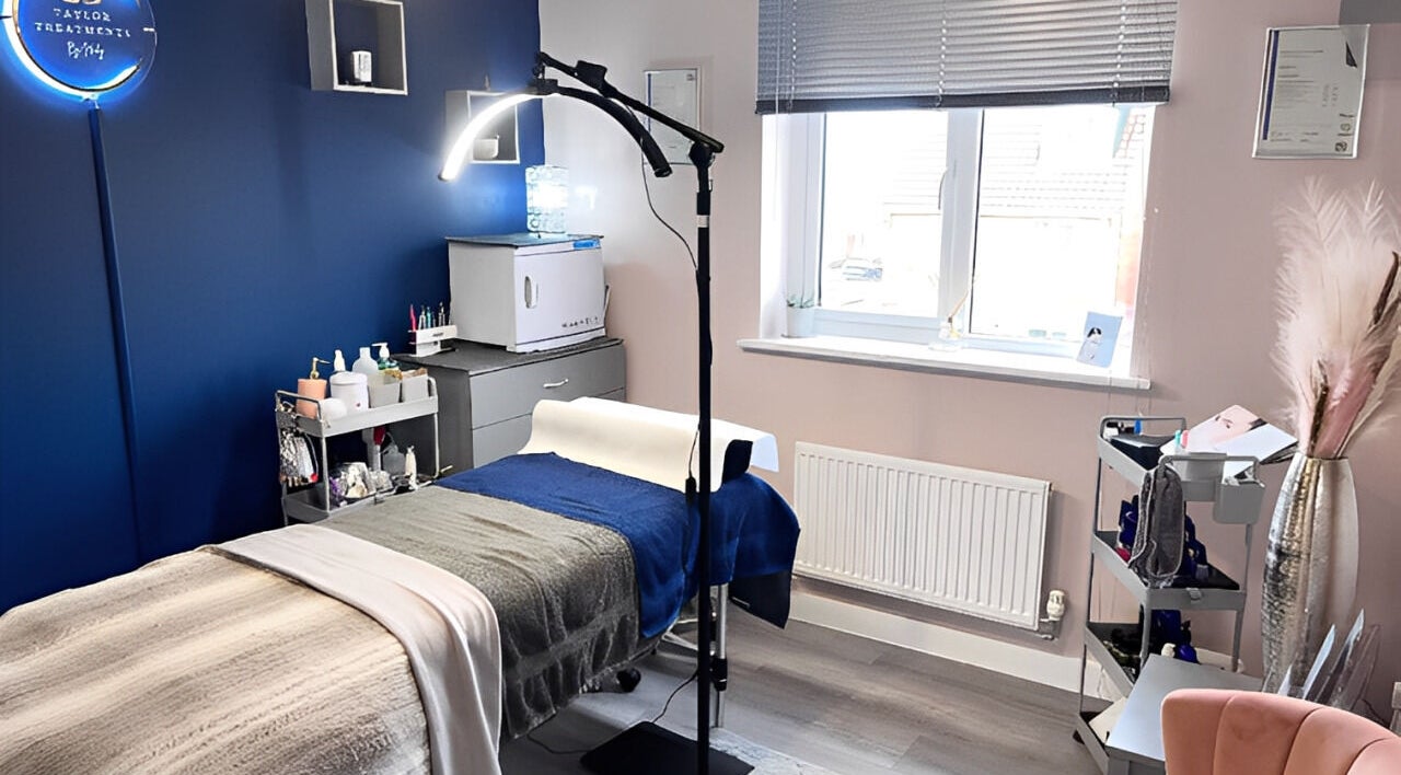 Cozy treatment room at Taylor Treatments, Hadleigh, England, GB, featuring plush bedding and elegant decor.