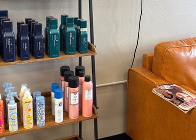 Product display and seating area at Shear Heaven Salon, Ruston, Louisiana, US, showcasing hair care products.