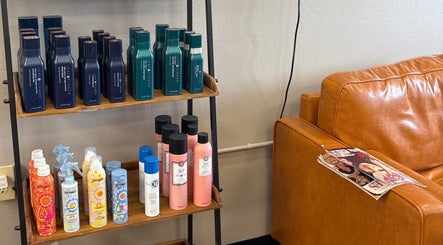 Product display and seating area at Shear Heaven Salon, Ruston, Louisiana, US, showcasing hair care products.