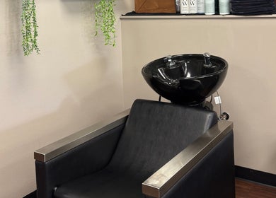 Modern wash station at Shear Heaven Salon, Ruston, Louisiana, US with sleek black basin and chair.