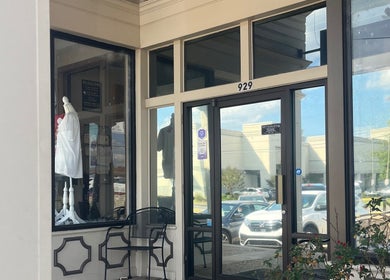 Entrance of Shear Heaven Salon in Ruston, Louisiana, showing glass doors and chic decor.