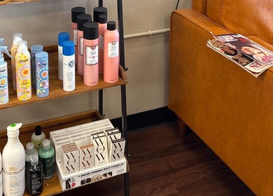 Product display at Shear Heaven Salon, Ruston, Louisiana, US featuring hair care items and cozy seating.