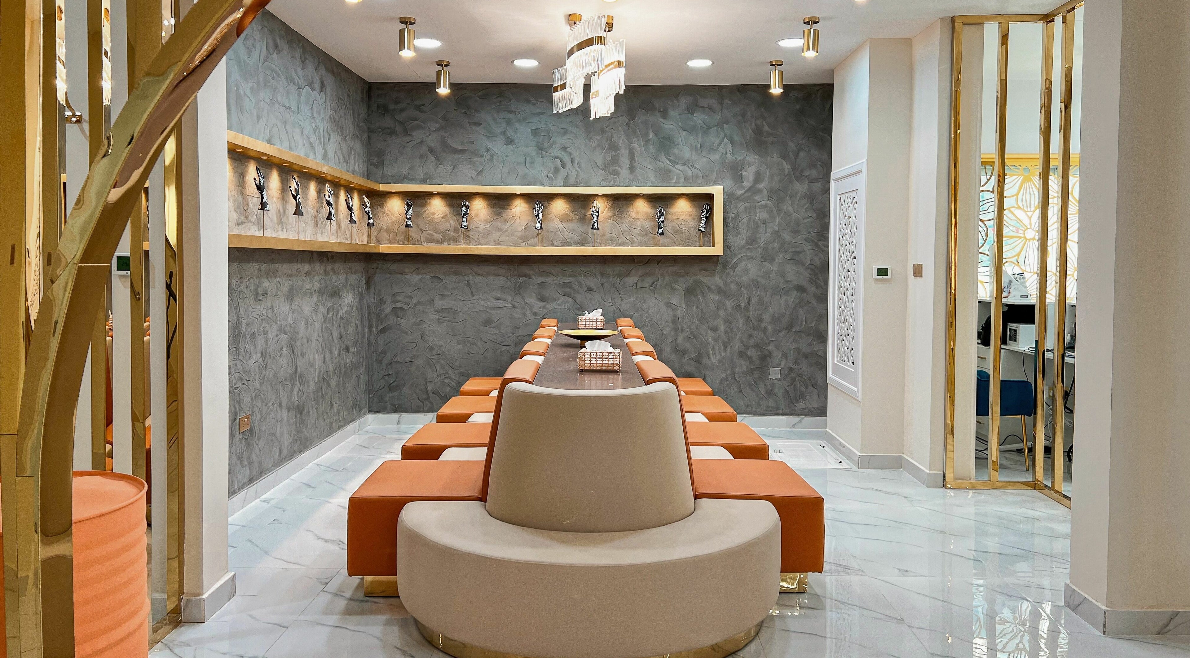 Chic interior of Fouziana Henna and Beauty Lounge, Abu Dhabi, AE; modern seating and decor.