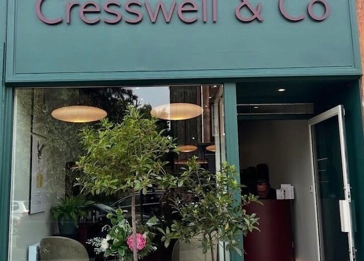 Front view of Cresswell Studios, Glasgow, Scotland, GB, featuring shop sign, greenery, and open entrance.