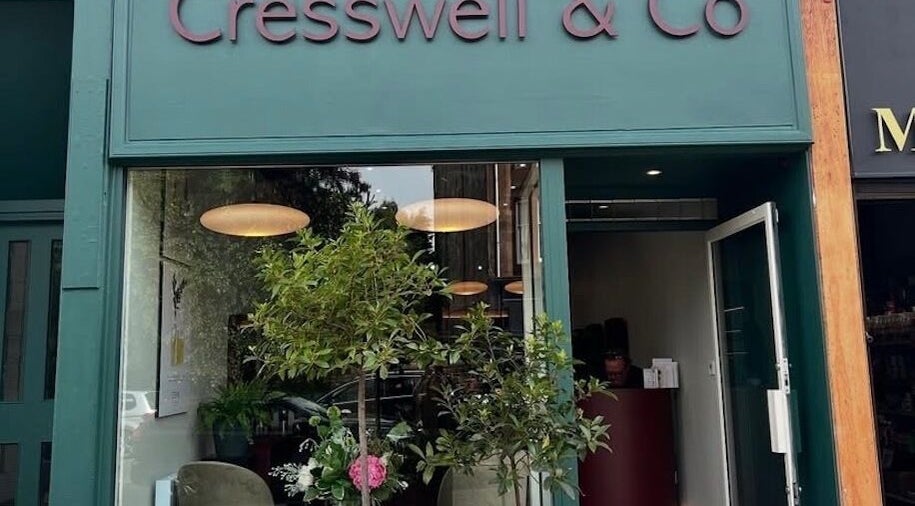 Front view of Cresswell Studios, Glasgow, Scotland, GB, featuring shop sign, greenery, and open entrance.