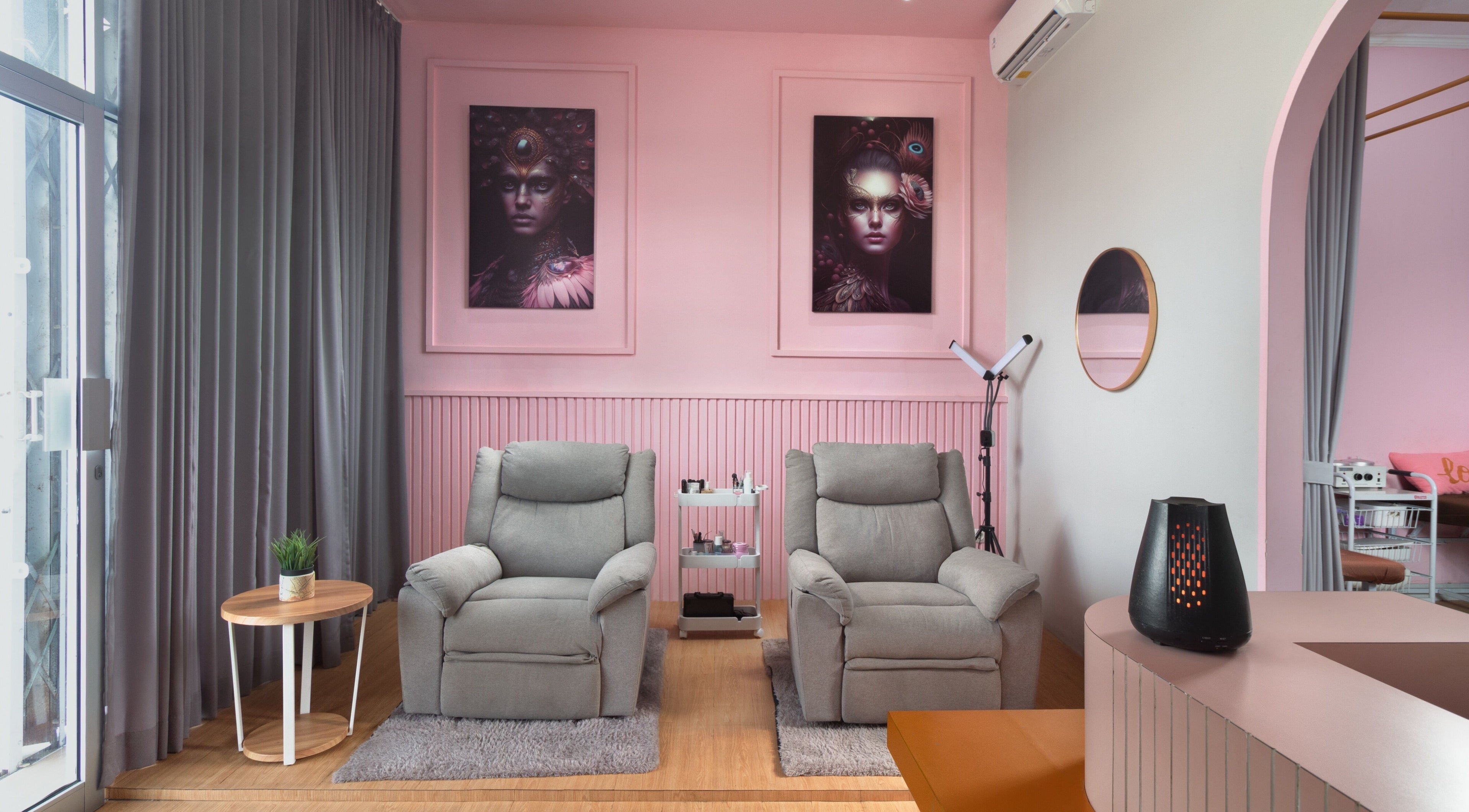 Cozy spa chairs at Misstia Beauty, Bali, Bali, ID with soft pink decor and elegant artwork.