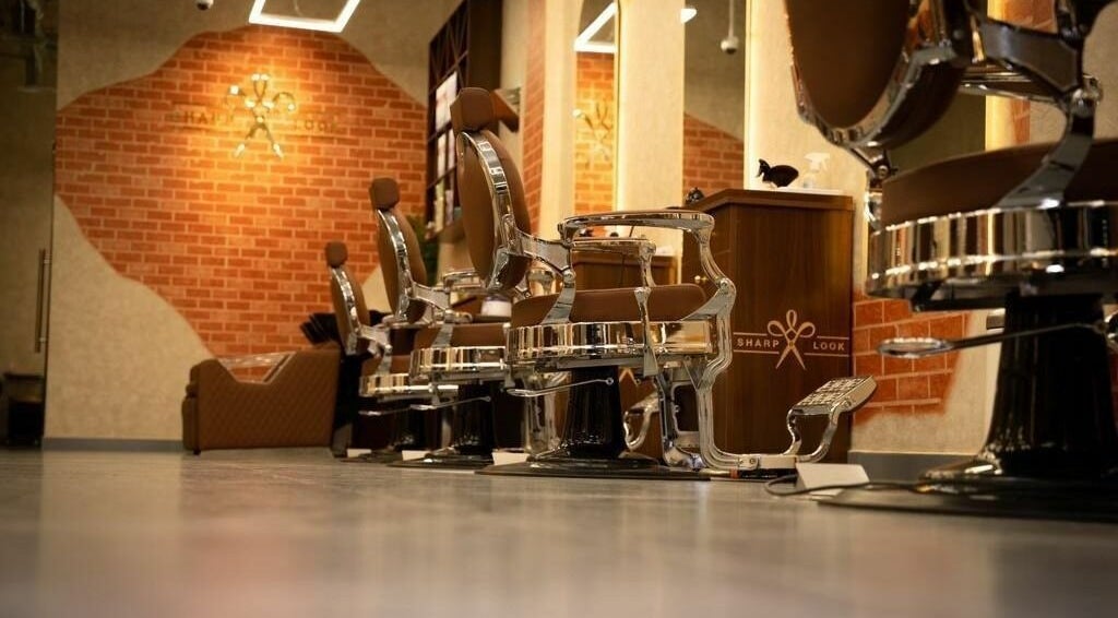 Sleek barber chairs at شارب لوك حطين - Sharp Look Hittin, Riyadh, Riyadh Province, SA, in a stylish setting.