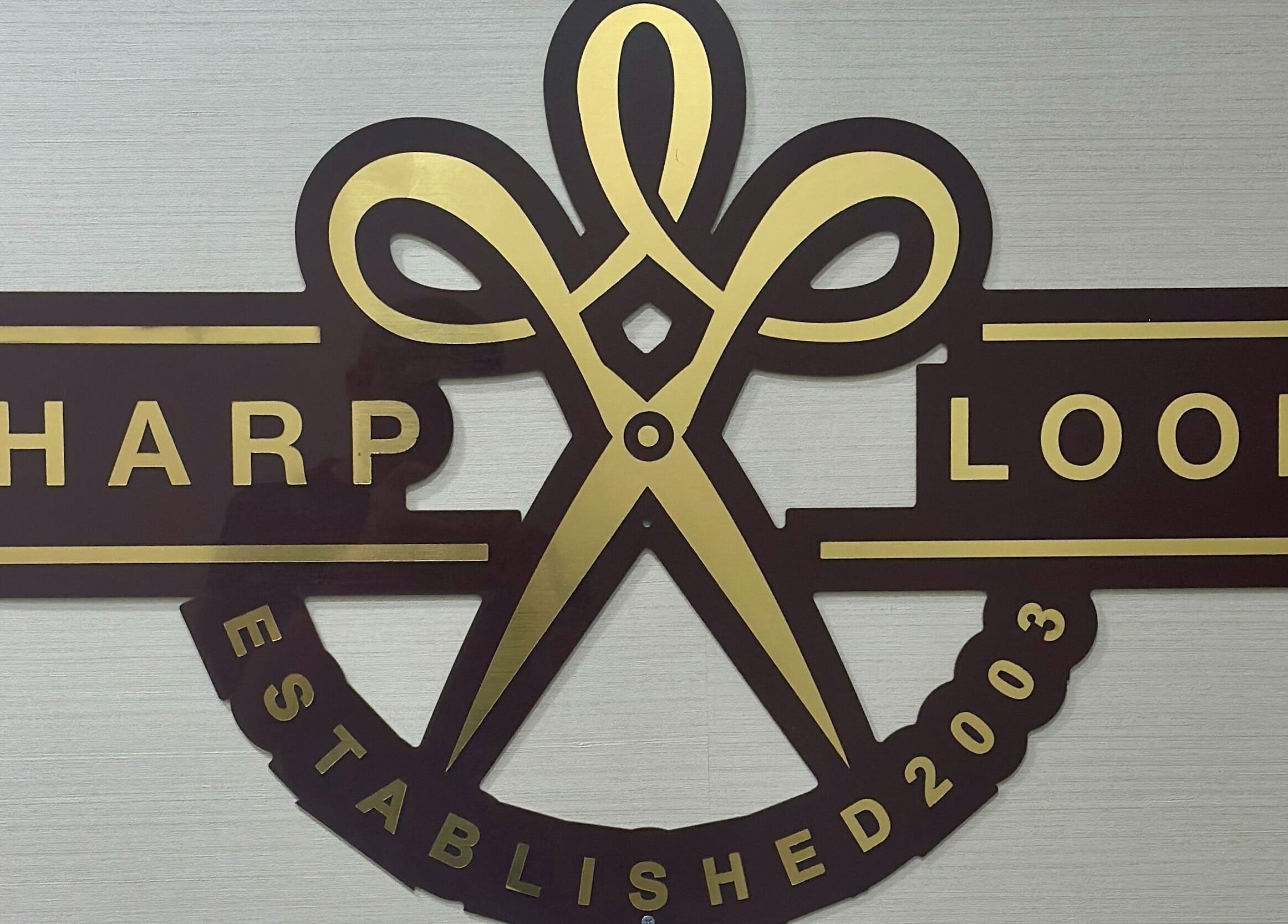 Sharp Look | Hilton Olaya sign at الرياض, منطقة الرياض, SA, featuring stylish scissors logo.