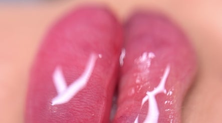 Close-up of glossy pink lips showcasing expert makeup at Paradox Aesthetics, Worcester, England, GB.