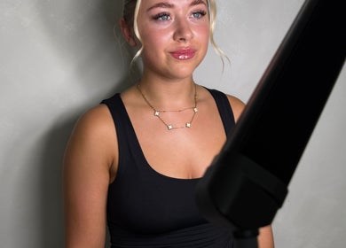 Young woman at Paradox Aesthetics, Worcester, England, GB, showcasing glowing skin and styled hair.