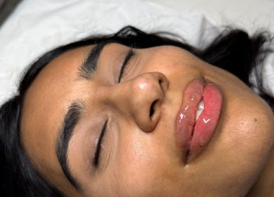 Peaceful woman with glossy lips at Paradox Aesthetics, Worcester, England, GB