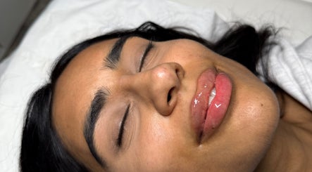 Peaceful woman with glossy lips at Paradox Aesthetics, Worcester, England, GB