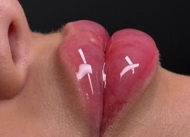 Close-up of glossy lips with creative white accents at Paradox Aesthetics, Worcester, England, GB.