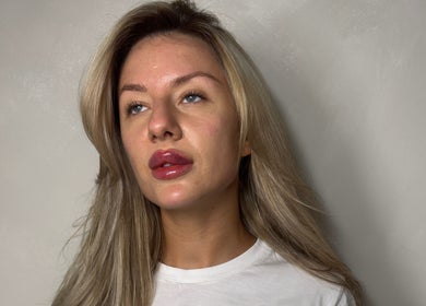 Portrait of a woman with glowing skin at Paradox Aesthetics, Worcester, England, GB.