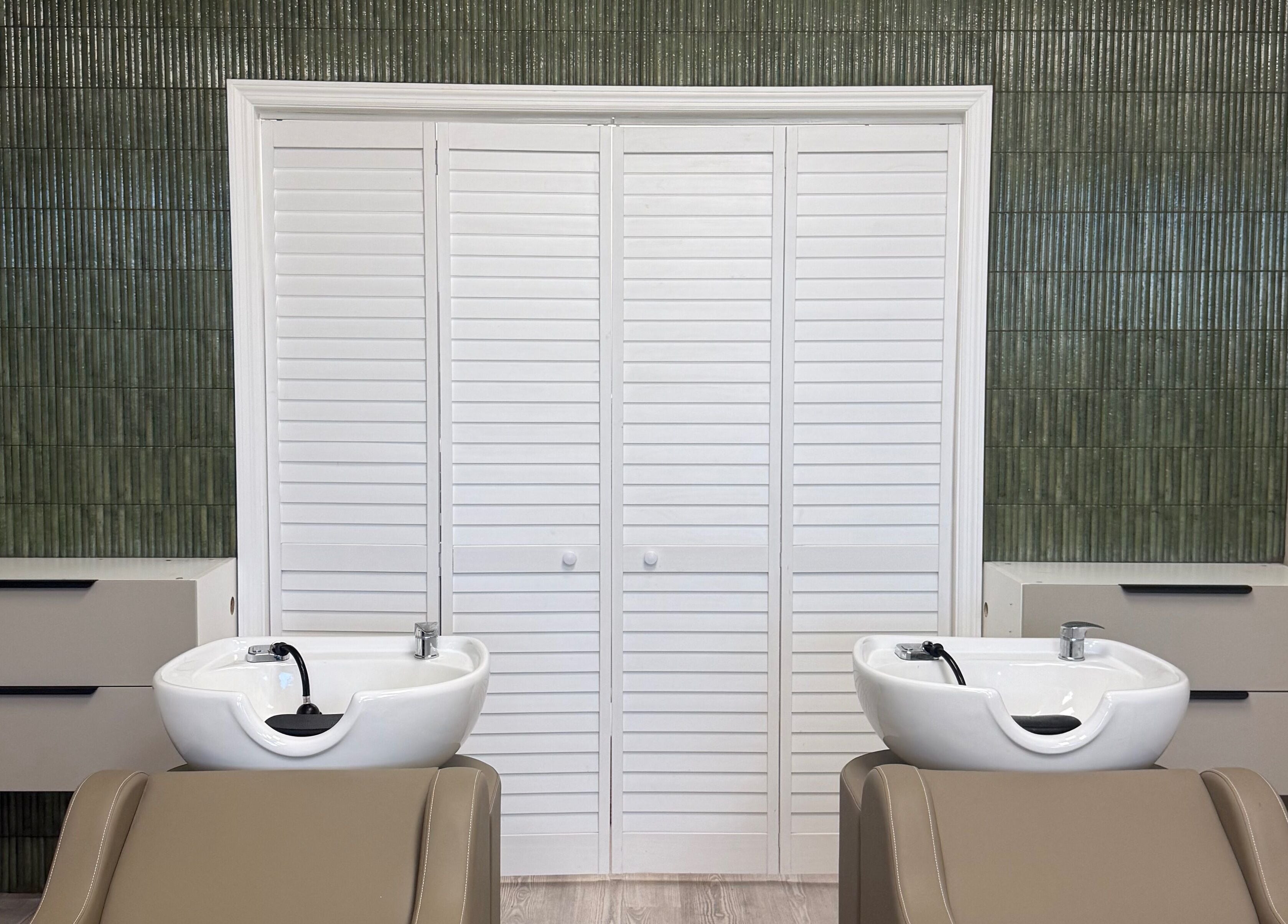 Luxurious wash stations at Curated Color & Extensions in Tampa, Florida, US, showcasing sleek design.