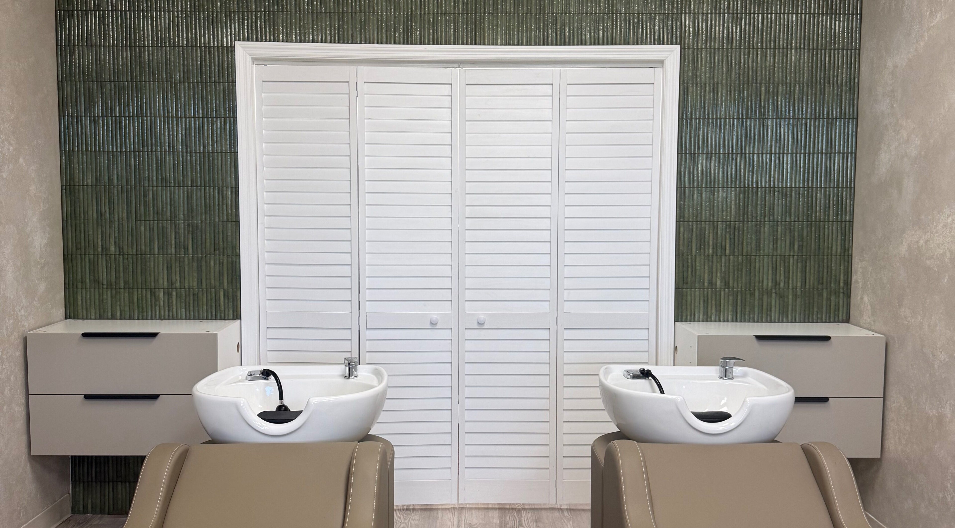 Luxurious wash stations at Curated Color & Extensions in Tampa, Florida, US, showcasing sleek design.