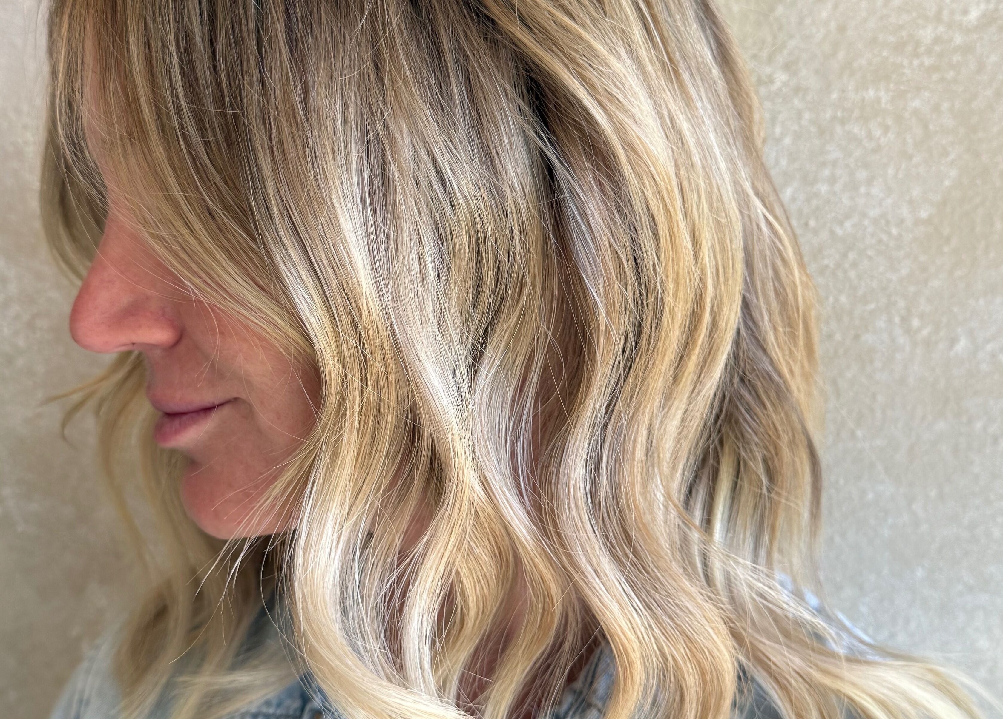 Blonde wavy hairstyle at Curated Color & Extensions, Tampa, Florida, US.